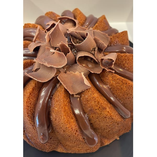 A Brazilian bundt cake from Cafezinho, drizzled with chocolate and topped with chocolate shavings.